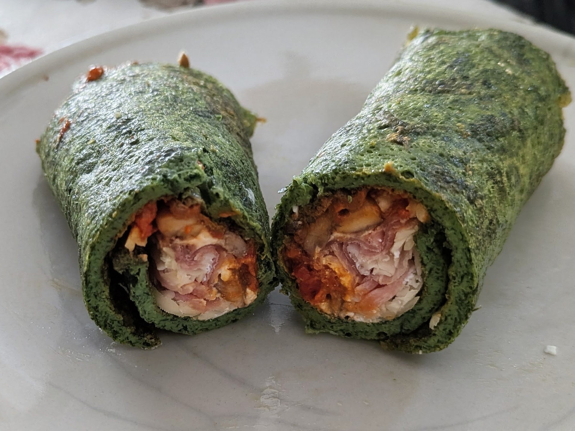 Spinach pancakes with ajvar, cheese and salami